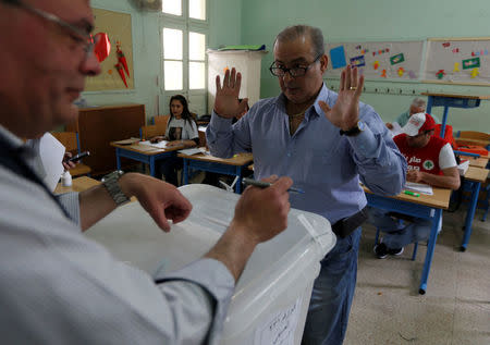 A man gestures after casting his vote at a polling station during the parliamentary election in Beirut, Lebanon, May 6, 2018. REUTERS/Jamal Saidi