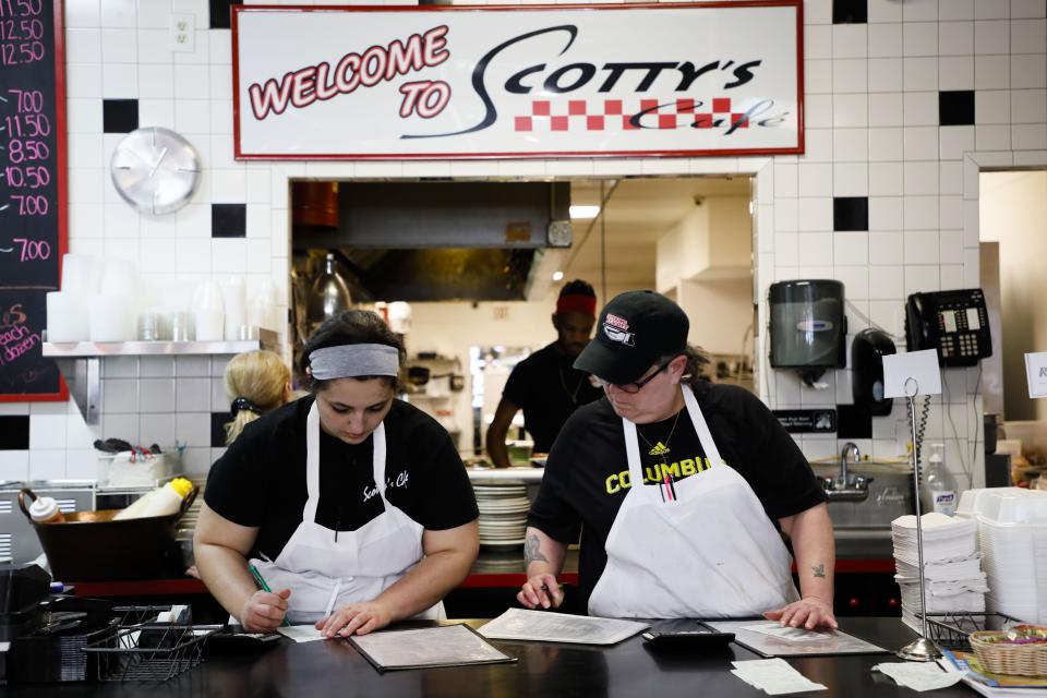 Audriana Bast, left, and Kim Arrowood, right, write down take-out orders while working at Scotty's Cafe on Friday, January 17, 2020, in Columbus, Ohio.