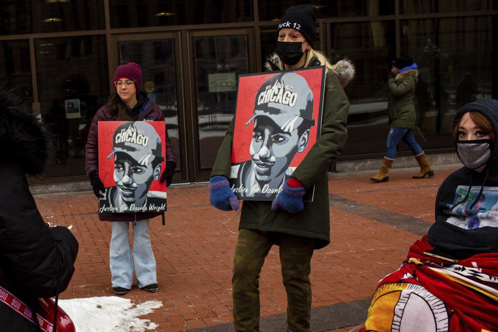 Demonstrators hold Justice for Daunte Wright signs Friday, Feb. 18, 2022 in Minneapolis. (AP Photo/Nicole Neri )