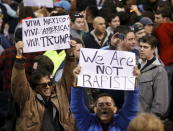 Demonstrators hold signs and cheer after Republican U.S. presidential candidate Donald Trump cancelled his rally at the University of Illinois at Chicago March 11, 2016. REUTERS/Kamil Krzaczynski