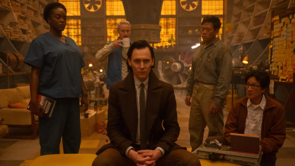 Loki and his TVA friends sitting in O.B.'s workshop in Loki Season 2.