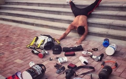 One man poses with his gym equipment for the 'flaunt your wealth' craze