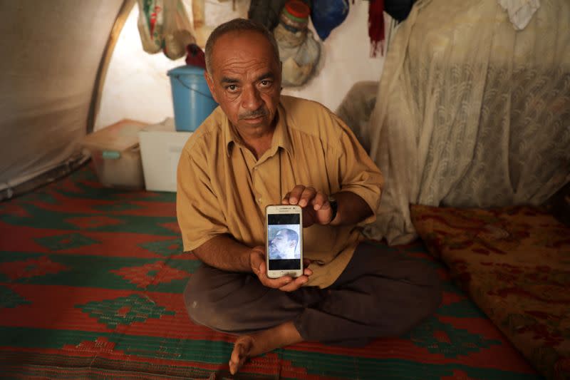 Khaled Mohamed al-Ahmed, 52, displays a picture of his deceased nephew in Idlib