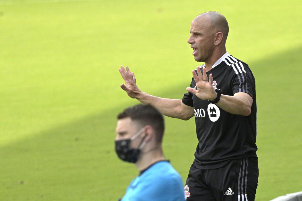 Toronto FC head coach Chris Armas, right, calls out instructions during the first half of an MLS soccer match against the Vancouver Whitecaps, Saturday, April 24, 2021, in Orlando, Fla. (AP Photo/Phelan M. Ebenhack)