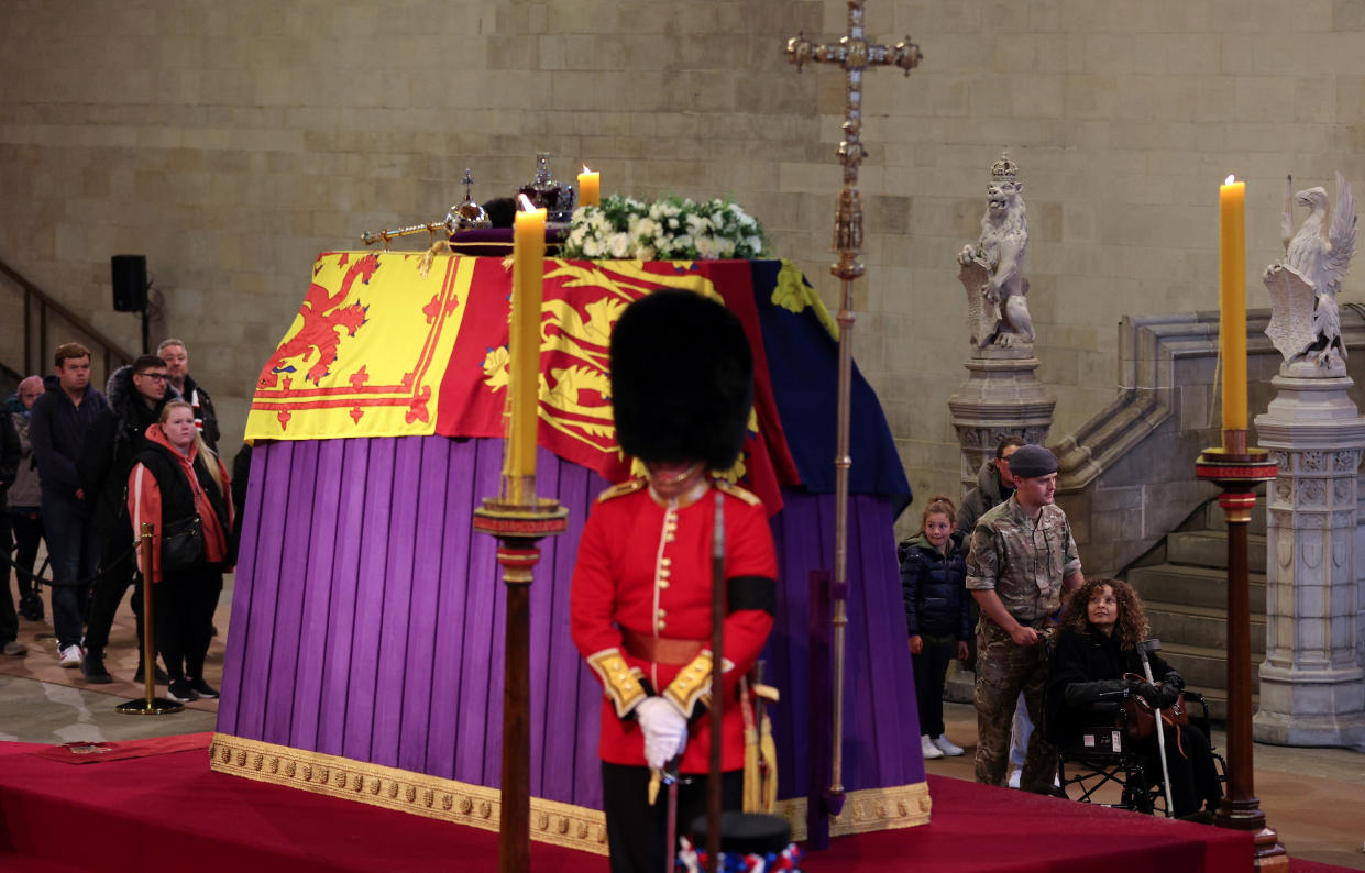 Members of the public pay their respects as they pass the coffin of Queen Elizabeth II, Lying in State inside Westminster Hall, at the Palace of Westminster in London, Sunday, Sept. 18, 2022. (Adrian Dennis/Pool Photo via AP)