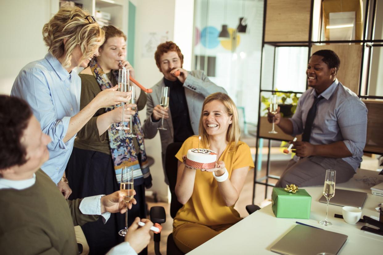 Close up of a group of designers having a birthday party at their office