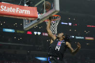 Los Angeles Clippers guard Terance Mann (14) scores during the first half of an NBA basketball game against the Boston Celtics in Los Angeles, Wednesday, Dec. 8, 2021. (AP Photo/Ashley Landis)