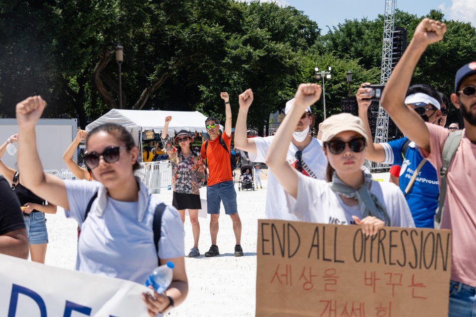 Demonstrators raise their fists during the Unity March rally (Eric Lee / Bloomberg via Getty Images)