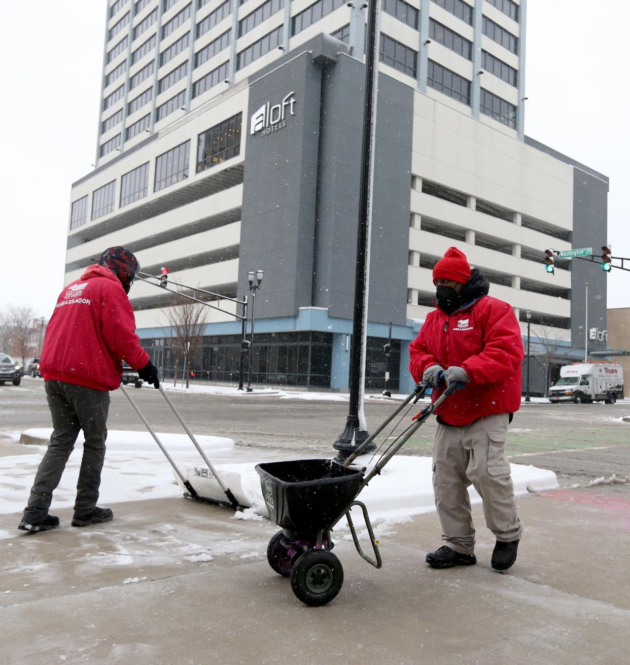 Downtown South Bend employees Chris Dokey, left, and Emmitt Long clear snowfall Friday, Jan. 12, 2024, at Main and Washington streets in downtown South Bend. The snowfall this weekend will give way to single digit temperatures and sub-zero windchills to start next week.