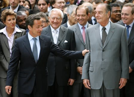 FILE PHOTO: File photo of France's incumbent President Chirac and newly-elected President Sarkozy attending a ceremony to pay tribute to the abolition of slavery in Paris