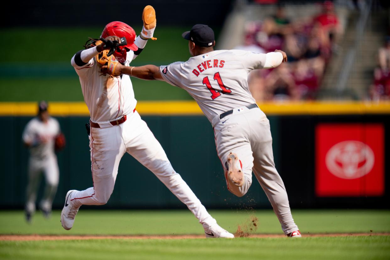 Red Sox third baseman Rafael Devers tags out Elly De La Cruz  after De La Cruz was picked off second base in the fifth inning of Saturday's game at Great American Ball Park. Fans are showing increasing frustration with the team's poor fundamental play.