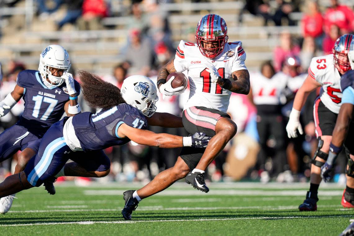 Dec 18, 2023; Charlotte, NC, USA; Western Kentucky Hilltoppers wide receiver Malachi Corley (11) runs the ball against Old Dominion Monarchs linebacker Koa Naotala (47) during the first quarter at Charlotte 49ers’ Jerry Richardson Stadium. Mandatory Credit: Jim Dedmon-USA TODAY Sports