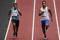 Adrian Ililau, of Palau, and Scott Fiti, of Federated States of Micronesia, compete in a heat in the men's 100-meter run at the 2020 Summer Olympics, Saturday, July 31, 2021, in Tokyo. (AP Photo/Charlie Riedel)