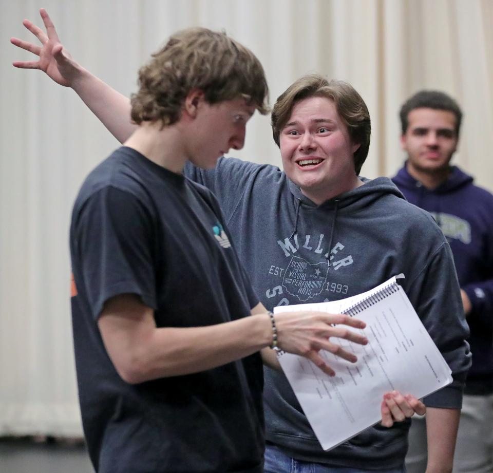 SpongeBob, played by junior Kyle McFalls, facing, runs through a scene with Squidward, played by senior Stanley Niekamp, during rehearsal for "The SpongeBob Musical" at Firestone CLC in Akron Feb. 29.