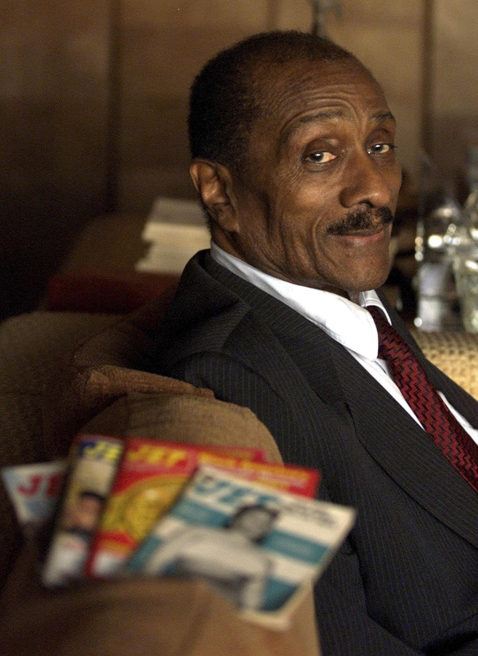 FILE - In this Dec. 10, 2001, file photo, Jet magazine founder John H. Johnson, head of Johnson Publishing Co., sits in his Chicago office. Johnson, Chicago's iconic Johnson Publishing Co., owner for decades of Ebony and Jet magazines that helped change the image of black people portrayed by U.S. media, filed Tuesday, April 9. 2019, for bankruptcy liquidation in federal court. (AP Photo/Ted S. Warren, File)