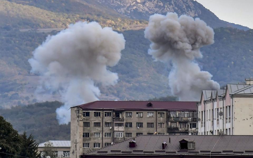 Smoke rises after shelling in Stepanakert on October 9 - AFP