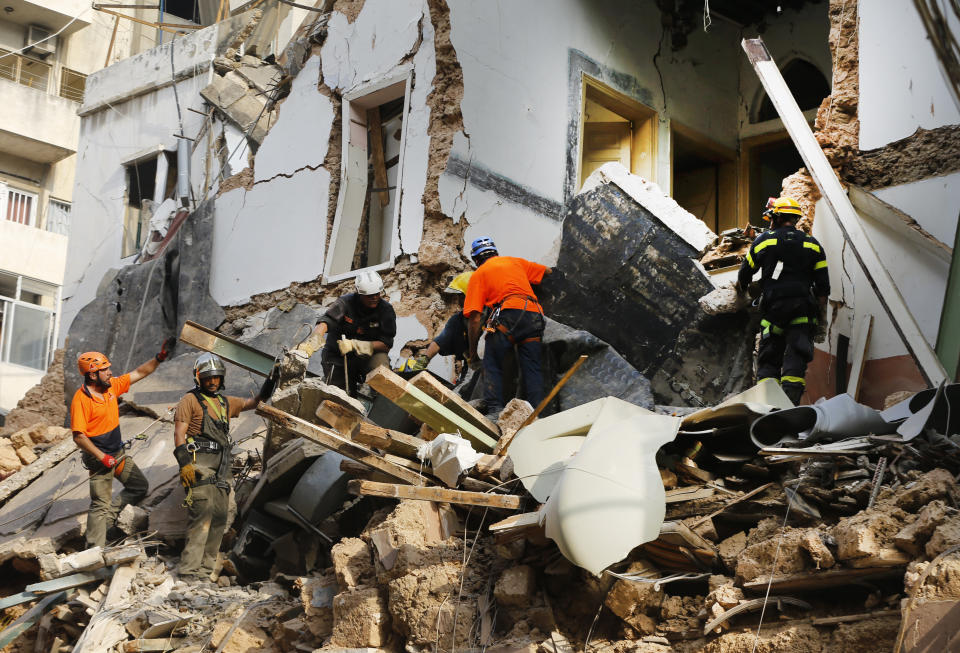 Chilean and Lebanese rescuers search in the rubble of a building that was collapsed in last month's massive explosion, after getting signals there may be a survivor under the rubble, in Beirut, Lebanon, Thursday, Sept. 3, 2020. Hopes were raised after the dog of a Chilean search and rescue team touring Gemmayzeh street, one of the hardest-hit in Beirut, ran toward the collapsed building. (AP Photo/Bilal Hussein)