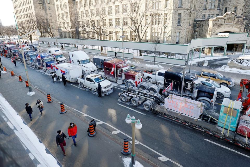 Vehicles line Wellington Street just west of Ottawa's Parliament Hill as truckers and supporters continue to protest COVID-19 rules Jan. 31, 2022. 
