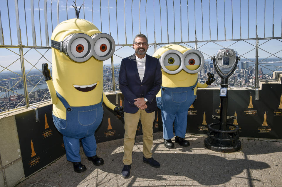 Actor Steve Carell and two Minion characters pose on the 86th floor observatory deck at the Empire State Building to celebrate the upcoming film "Minions: The Rise of Gru" on Tuesday, June 28, 2022, in New York. (Photo by Evan Agostini/Invision/AP)