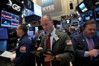 Traders work on the trading floor at the New York Stock Exchange (NYSE) in Manhattan, New York City, U.S., February 27, 2017. REUTERS/Andrew Kelly