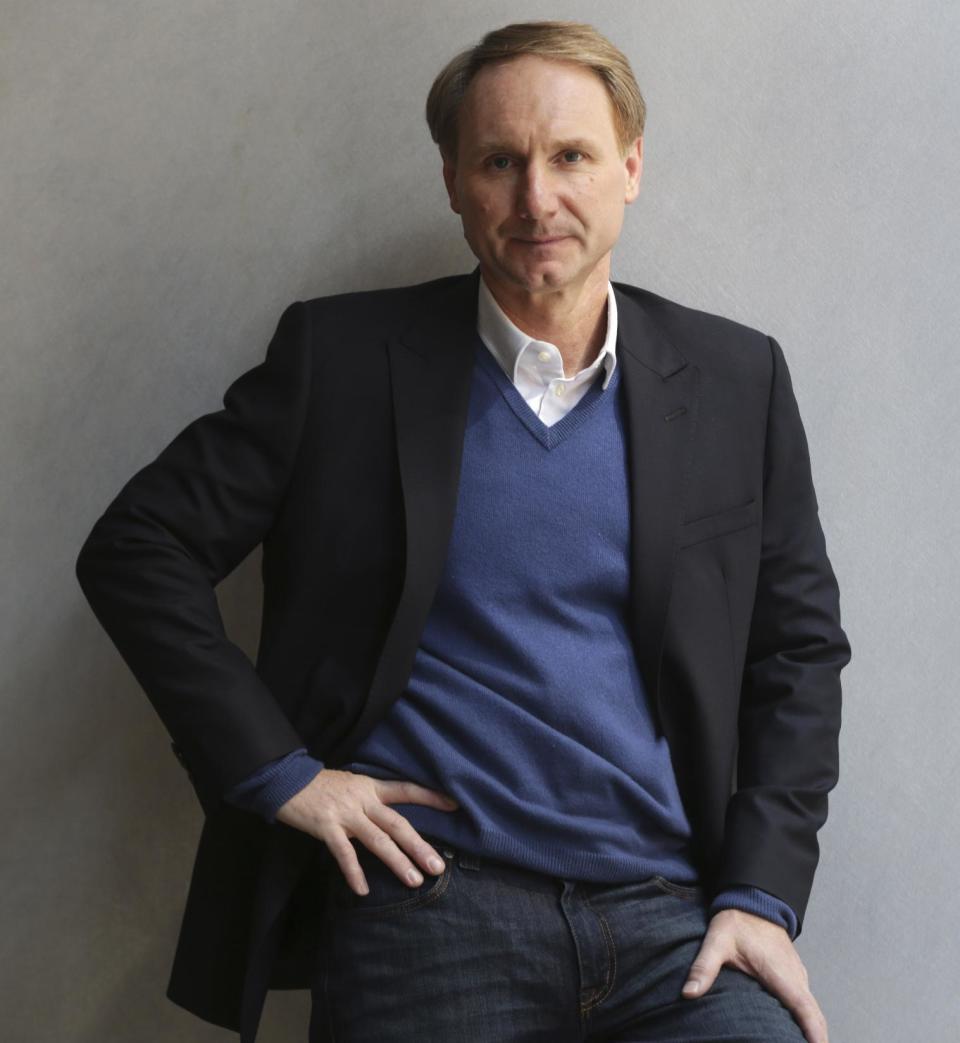 FILE - In this May 13, 2013 file photo, author Dan Brown poses for a portrait in New York. His new book, "Inferno," published by Doubleday released on May 14. No mega-sellers came out in 2013, nothing that compared with E L James' "Fifty Shades of Gray" or Stieg Larsson's crime novels. Adult readers turned to dependable favorites such as Dan Brown and Khaled Hosseini, while teens and grade-schoolers stuck with Rick Riordan, Jeff Kinney and Veronica Roth, whose "Divergent" series is set to debut on the big screen in 2014. (AP Photo/Seth Wenig, File)