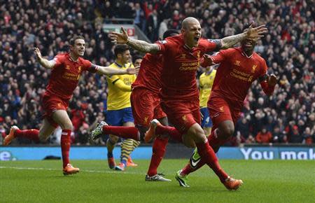 Liverpool's Martin Skrtel (C) celebrates scoring against Arsenal during their English Premier League soccer match at Anfield Stadium in Liverpool, northern England February 8, 2014. REUTERS/Nigel Roddis