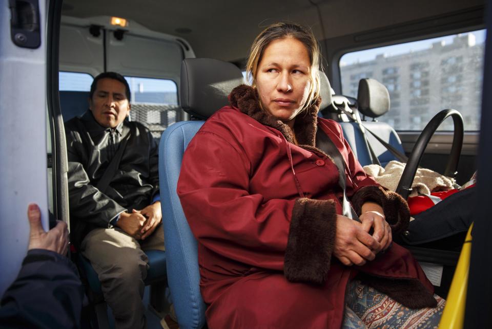 Paredes, her husband Ruilova, and their one-month-old son Dilan sit inside a social welfare vehicle after the family was evicted from their apartment in Madrid