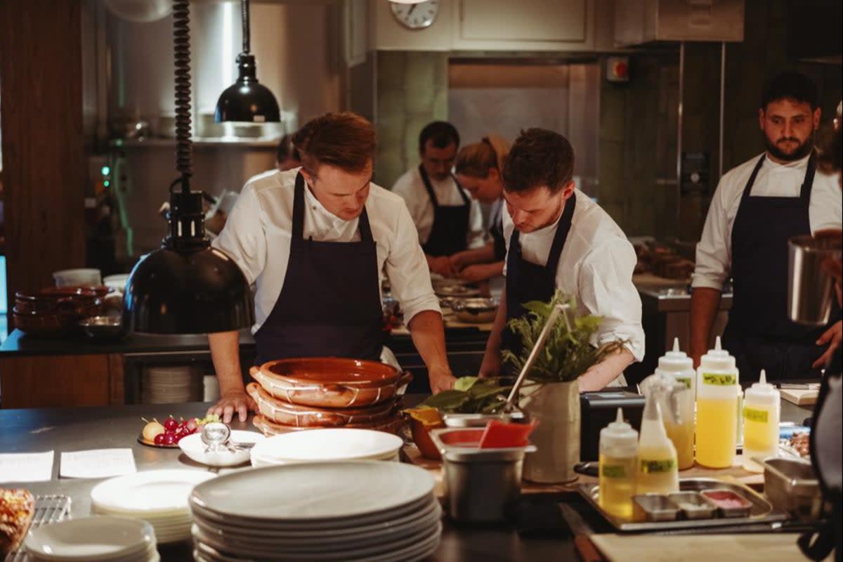 Cherubic features and a rock frontman’s flopping fringe: chef Tomos Parry, left, with his team  (Benjamin McMahon)