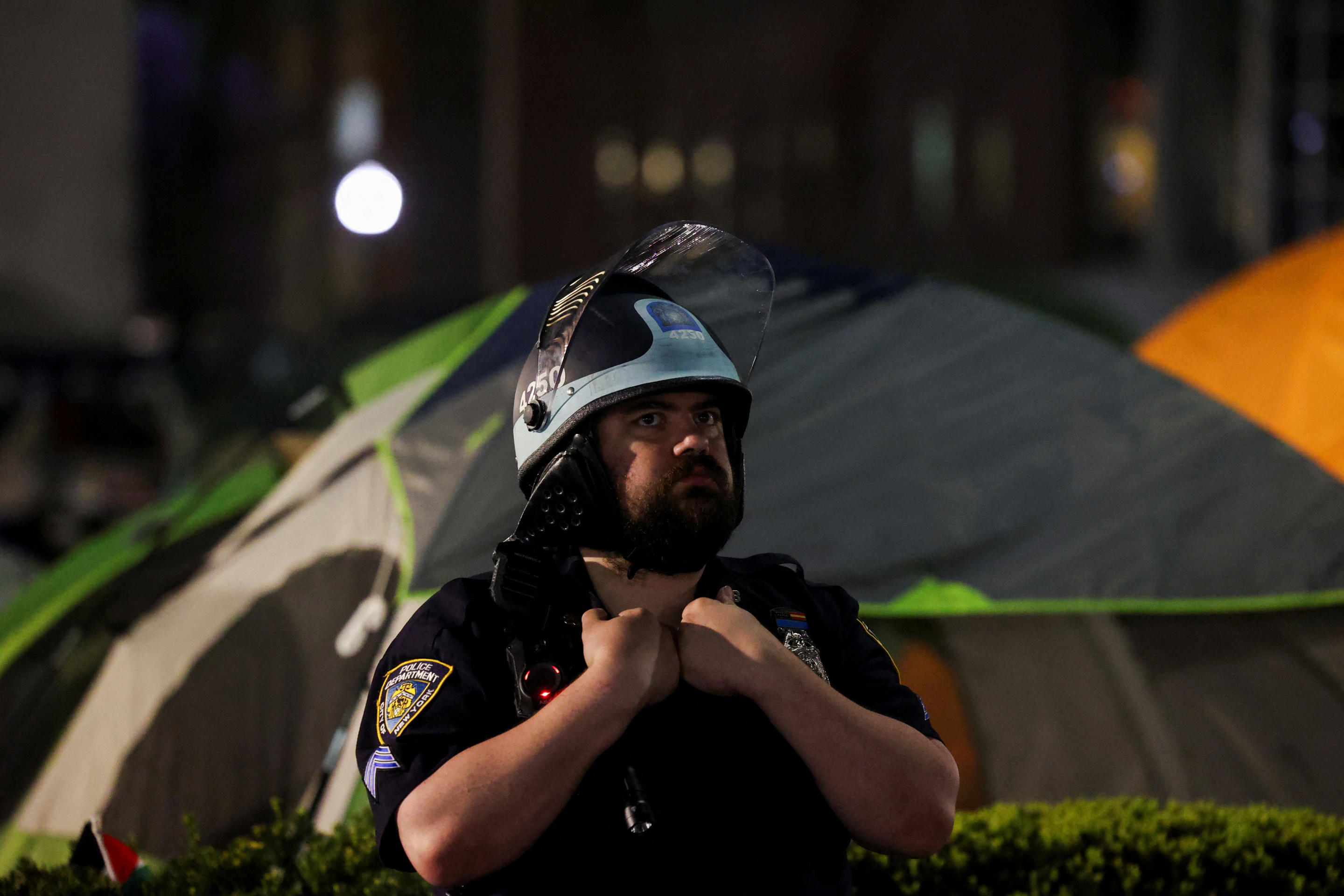 An NYPD official stands guard after establishing a perimeter at Columbia University. 