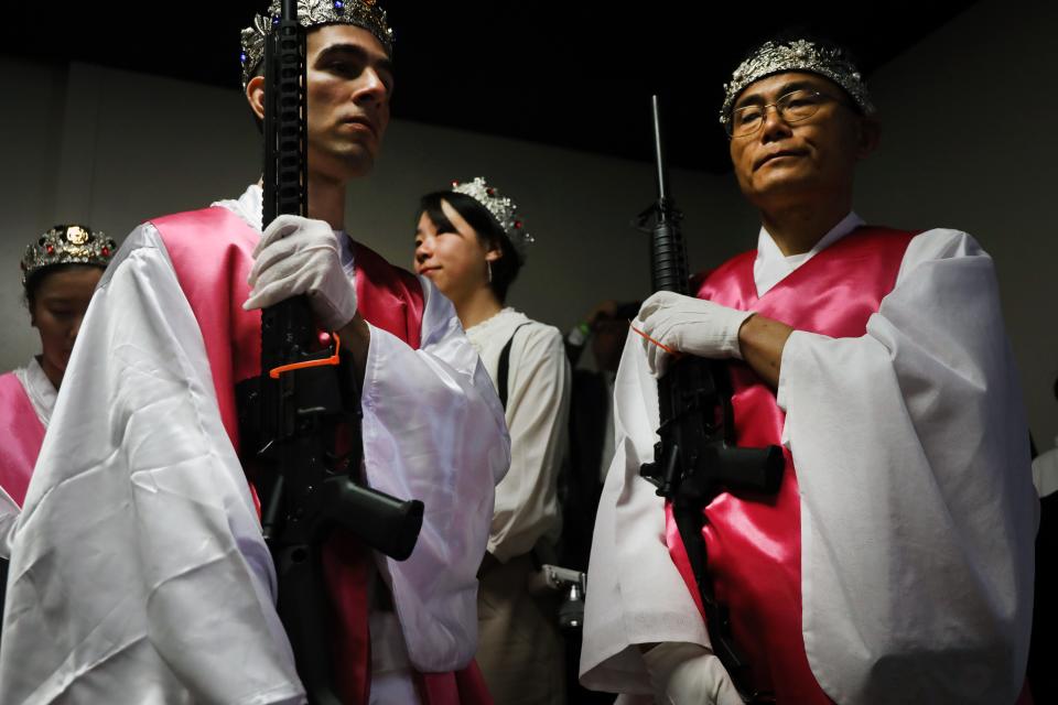 Members of the World Peace and Unification Sanctuary hold their AR-15 rifles as they participate in a Life Holy Marriage Blessing at the church on October 14, 2019 in Newfoundland, Pennsylvania.