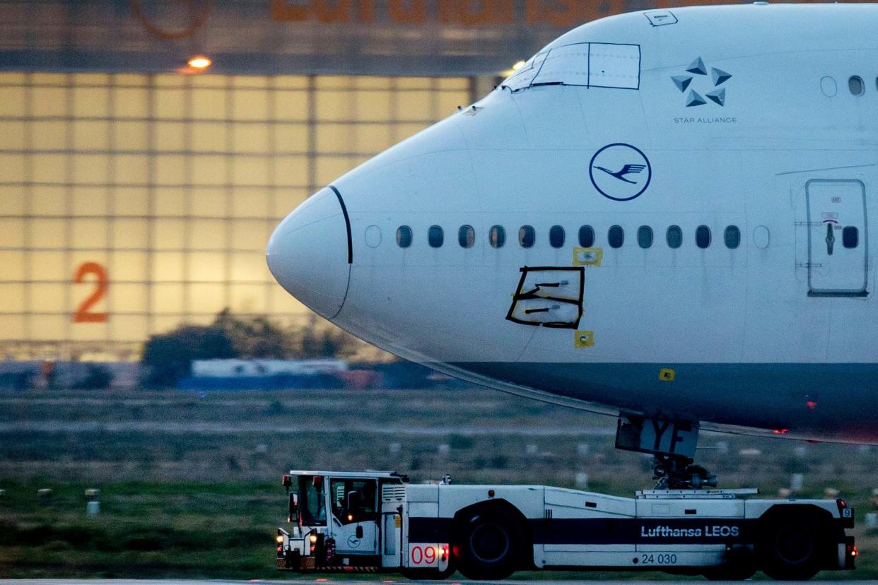 A Lufthansa Boeing 747 is pulled to a parking position at the airport in Frankfurt: AP