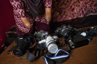 Armless professional photographer Rusidah, 44, carries out camera maintenance on March 13, 2012 in Purworejo, Indonesia. (Photo by Ulet Ifansasti/Getty Images)