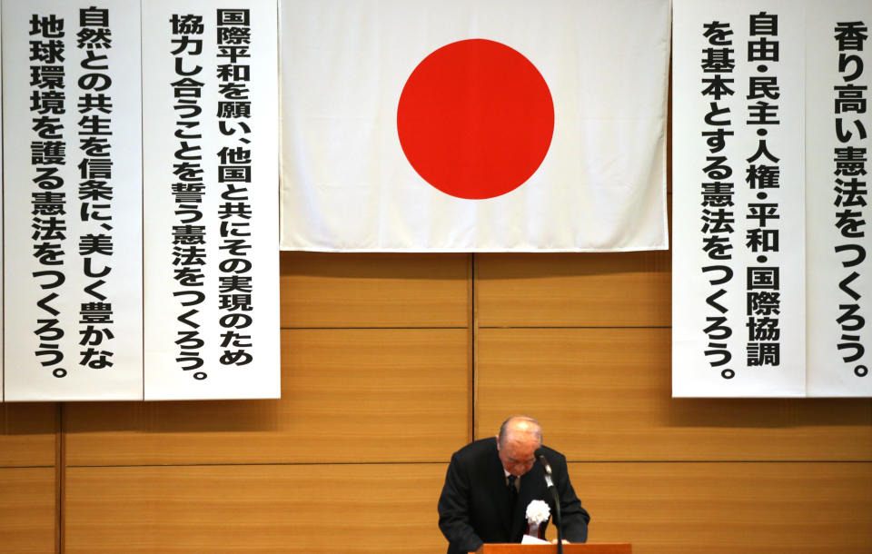 In this Thursday, May 1, 2014 photo, former Japanese Prime Minister Yasuhiro Nakasone bows after delivering a speech at a meeting of a pro-constitution amendment group in Tokyo. Japan is marking the 67th anniversary of its postwar constitution on May 3, 2014 with growing debate over whether to revise the war-renouncing document. Prime Minister Shinzo Abe’s ruling conservative party has long advocated revision but been unable to sway public opinion. Now he proposes that the government reinterpret the constitution so it can loosen the reins on its military without having to win approval for constitutional change. (AP Photo/Eugene Hoshiko)