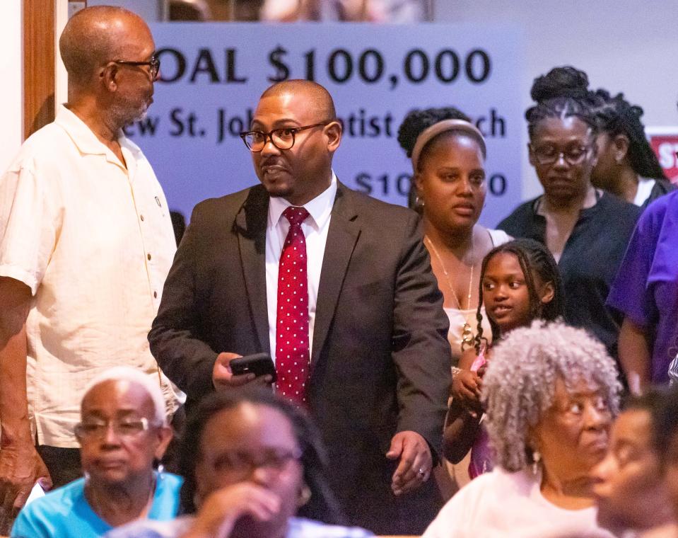 Attorney Anthony Thomas walks into the church with family members of Ajike Shantrell Owens Monday.