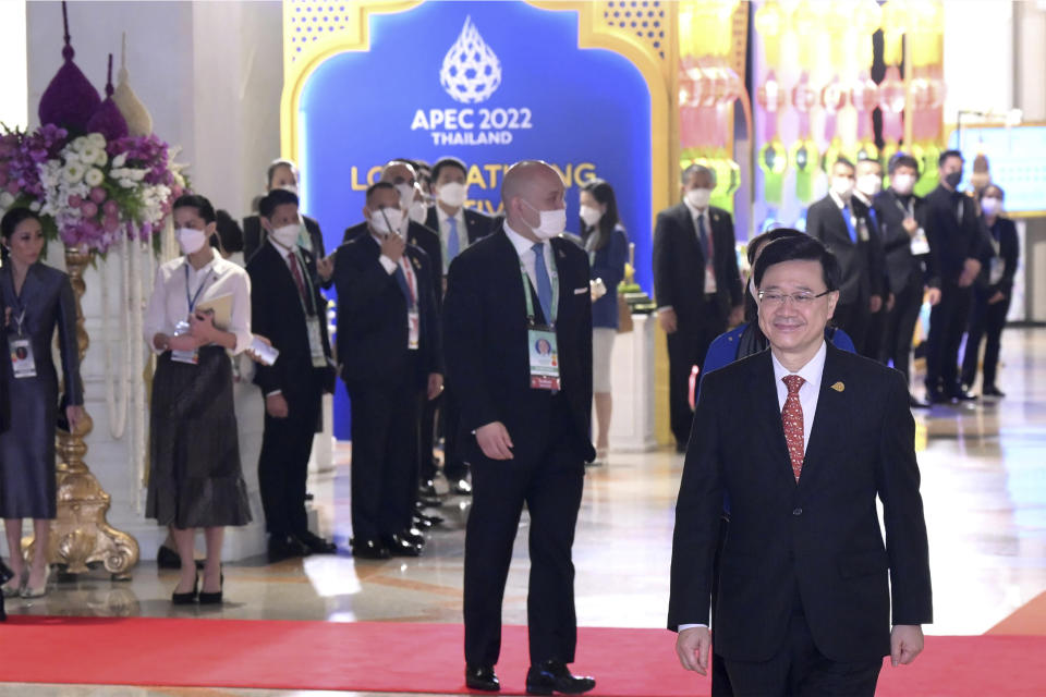 In this photo released by Hong Kong Government Information Services, Hong Kong Chief Executive John Lee, foreground right, attends a gala dinner at the Asia-Pacific Economic Cooperation (APEC) Summit in Bangkok, Thailand on Nov. 17, 2022. The Hong Kong government said Monday, Nov. 21, 2022 that leader John Lee tested positive for COVID-19 after returning from the Asia-Pacific Economic Cooperation meetings in Thailand. (Hong Kong Government Information Services via AP)