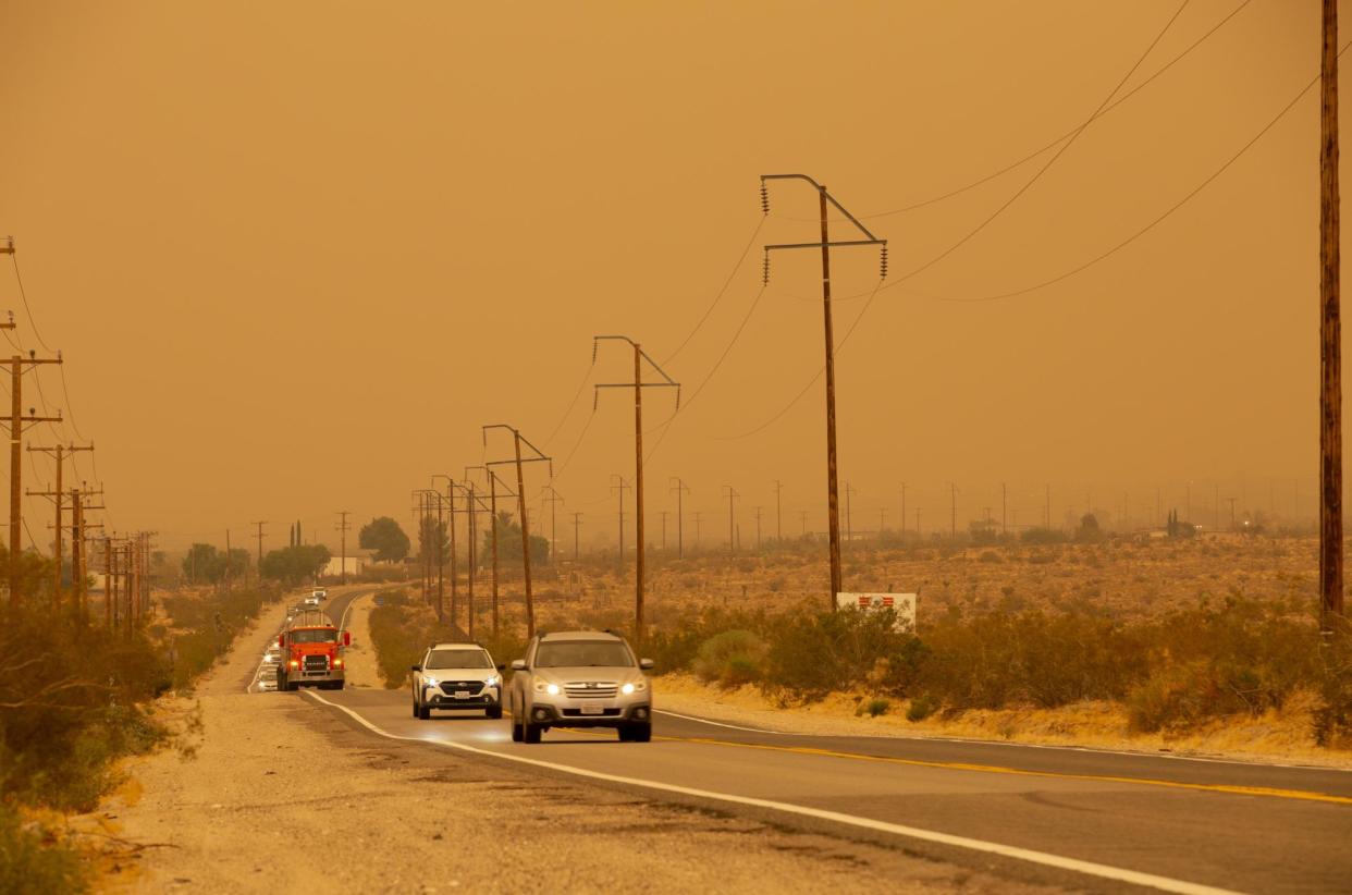 <span>Cars drive away from Big Bear Valley in Lucerne Valley, California, on Tuesday.</span><span>Photograph: Katrina Kochneva/Zuma Press Wire/Rex/Shutterstock</span>