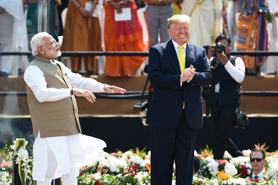 US President Donald Trump (R) and India's Prime Minister Narendra Modi greet the crowd during 'Namaste Trump' rally at Sardar Patel Stadium in Motera, on the outskirts of Ahmedabad, on February 24, 2020. (Photo by Money SHARMA / AFP) (Photo by MONEY SHARMA/AFP via Getty Images)