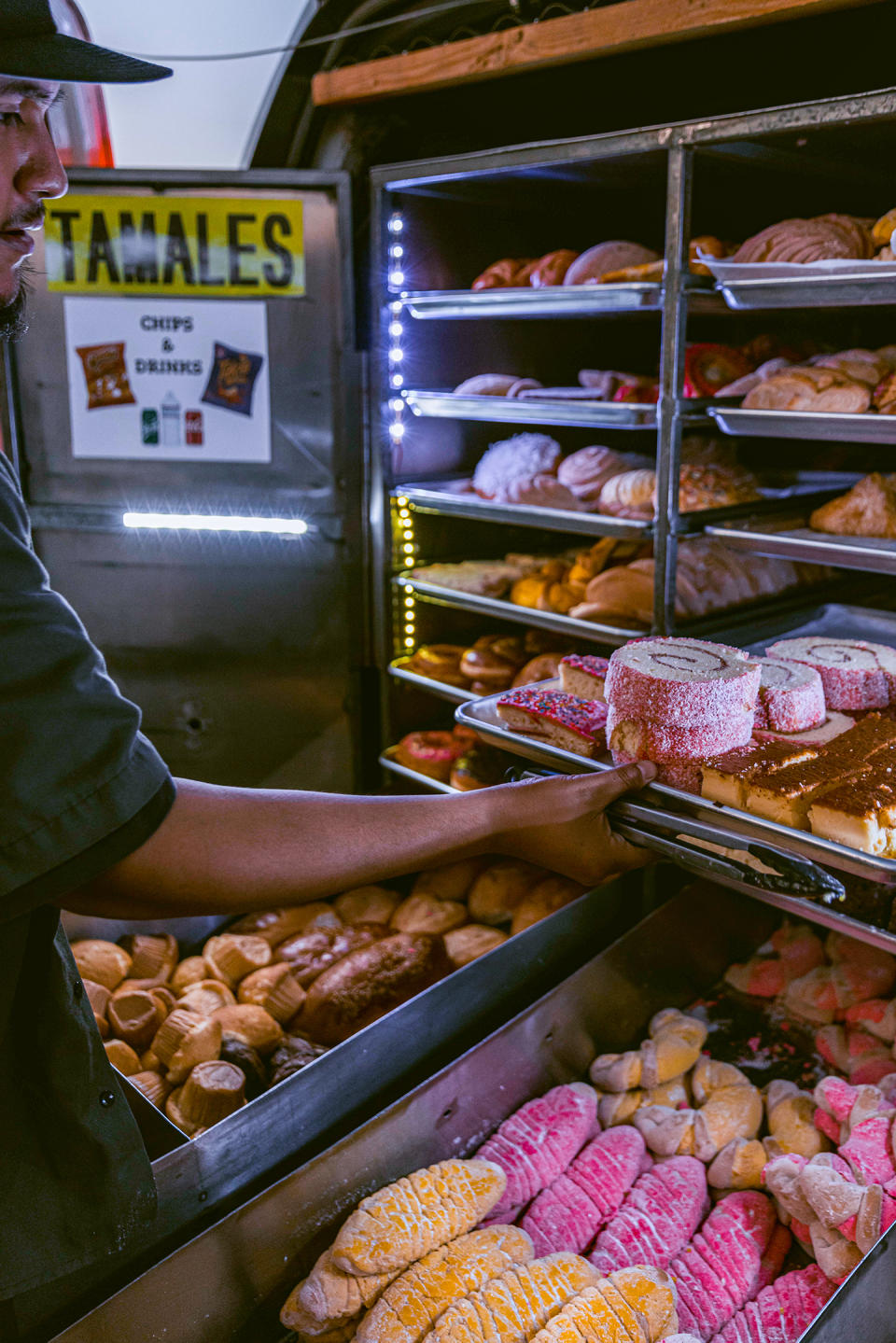 Ernesto Botello of Zeledon’s Bakery on Wheels with a selection of pan dulce. (@kamikomusic via Instagram / Courtesy Zeledon's Bakery on Wheels)