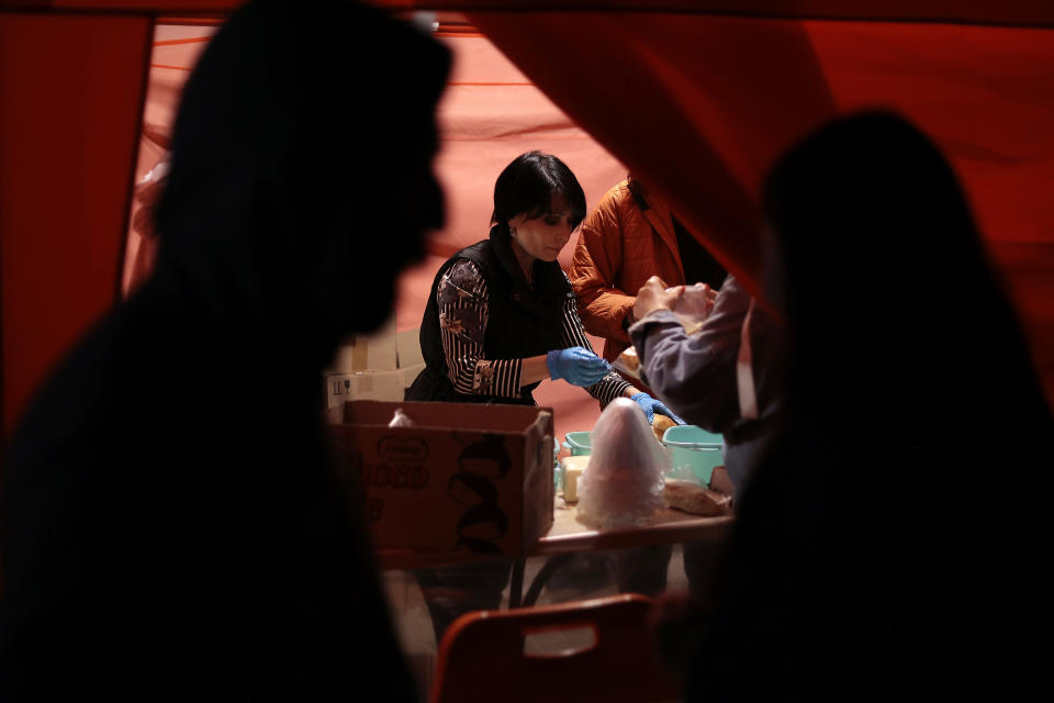 Volunteers distribute food to ethnic Armenians arriving from Nagorno-Karabakh in a camp in Armenia's Goris in Syunik region, Armenia, Thursday, Sept. 28, 2023. More than 70% of Nagorno-Karabakh's original population has fled to Armenia as the region's separatist government said it will dissolve itself and the unrecognized republic inside Azerbaijan will cease to exist by year’s end after a three-decade bid for independence. (AP Photo/Vasily Krestyaninov)