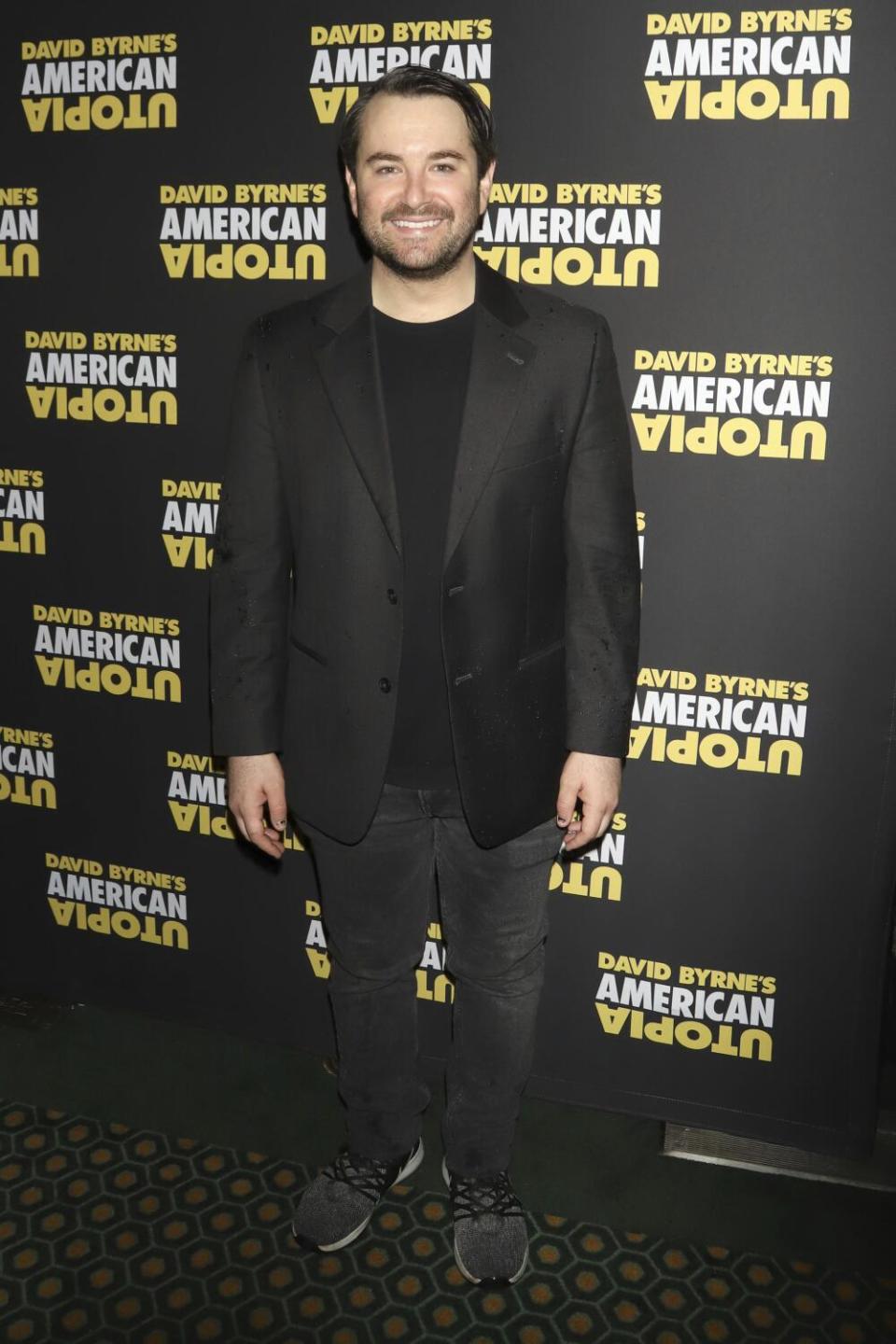 Alex Brightman standing against a black backdrop.