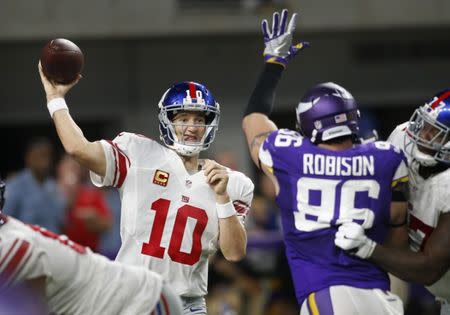 Oct 3, 2016; Minneapolis, MN, USA; New York Giants quarterback Eli Manning (10) passes against the Minnesota Vikings in the fourth quarter at U.S. Bank Stadium. Mandatory Credit: Bruce Kluckhohn-USA TODAY Sports