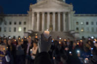 <p>Hundreds attend a candlelight rally in support of the ongoing statewide teachers walkout outside of the capitol building in Charleston, W.V., on Sunday, Feb. 25, 2018. (Photo: Craig Hudson/Charleston Gazette-Mail via AP) </p>