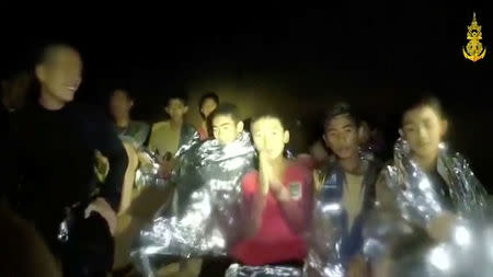 Boys from the under-16 soccer team trapped inside Tham Luang cave greet members of the Thai rescue team in Chiang Rai, Thailand, in this still image taken from a July 3, 2018 video by Thai Navy Seal. Thai Navy Seal/Handout via REUTERS TV