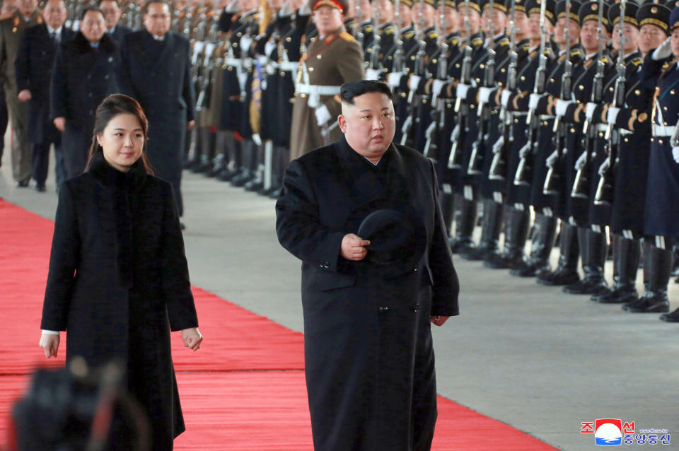 In this Monday, Jan. 7, 2019, photo provided on Tuesday, Jan. 8, 2019, by the North Korean government, North Korean leader Kim Jong Un walks with his wife Ri Sol Ju at Pyongyang Station in Pyongyang, North Korea, before leaving for China. While President Donald Trump waits in the wings, Kim arrived in Beijing on Tuesday for his fourth summit with China’s Xi Jinping, yet another nod to the leader Kim most needs to court as he tries to undermine support for international sanctions while giving up little, if any, ground on denuclearization. Independent journalists were not given access to cover the event depicted in this image distributed by the North Korean government. The content of this image is as provided and cannot be independently verified. Korean language watermark on image as provided by source reads: "KCNA" which is the abbreviation for Korean Central News Agency. (Korean Central News Agency/Korea News Service via AP)