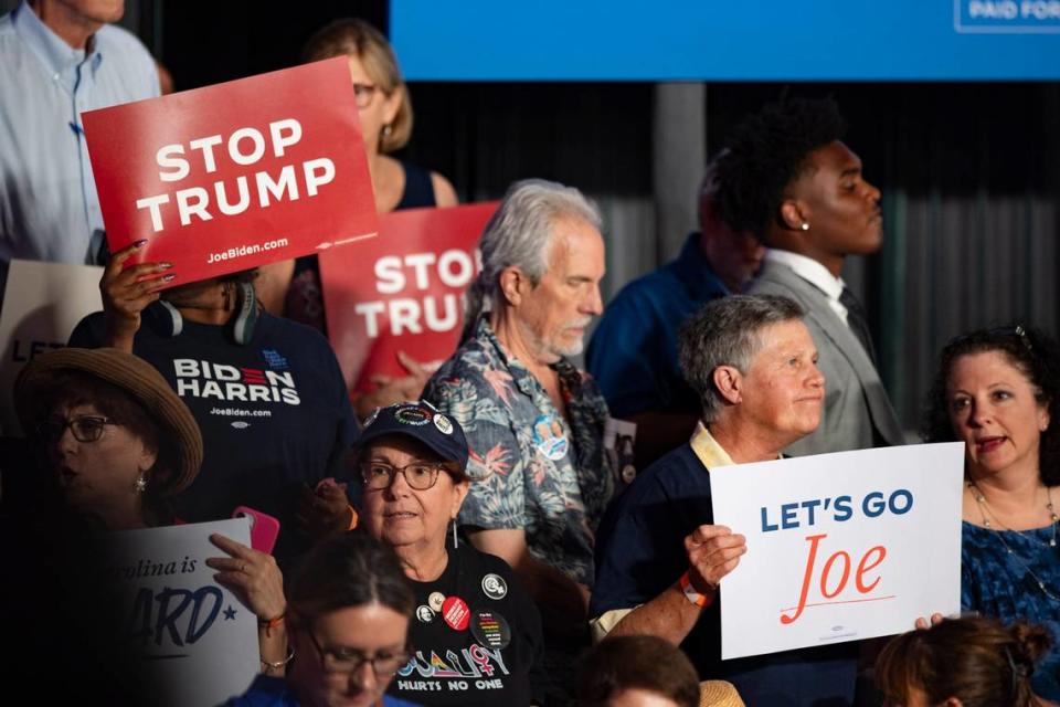 Supporters of President Joe Biden hold up signs at a campaign event at the Jim Graham building at the North Carolina State Fairgrounds in Raleigh on Friday June 28, 2024.