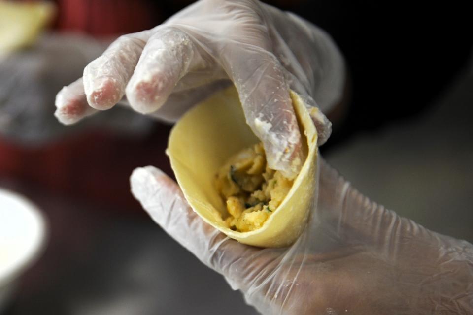 Samaira Ahmed presses together the flour wrap of a samosa, which is a deep fried pastry filled with spiced potatoes, that she is preparing for the Islamic Society of Evansville's International Food Festival on Monday, Sept. 18, 2023.