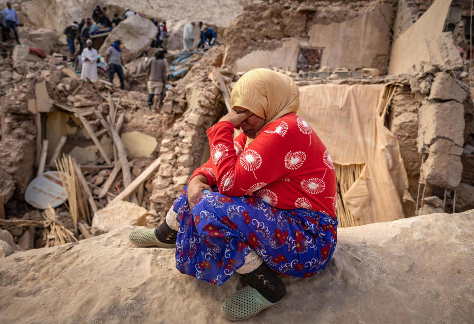 A woman reacts by the rubble of destroyed buildings in Imi N'Tala, Morocco. (Fadel Senna / AFP - Getty Images)