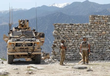 U.S. soldiers stand guard near the site of a U.S. bombing in the Achin district of Nangarhar province in eastern Afghanistan April 15, 2017. REUTERS/Parwiz