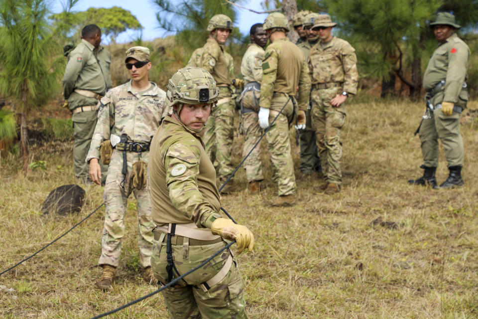 In this photo provided by U.S. Navy, a New Zealand soldier looks down his training descent rope during Exercise Cartwheel at Nausori Highlands Training Area, Fiji, on Sept. 18, 2022. A military exercise in Fiji involving the United States, Britain, Australia and New Zealand ends this week as the traditional allies counter China’s growing influence in the region.(Staff Sgt. Timothy Gray/U.S.Navy via AP)