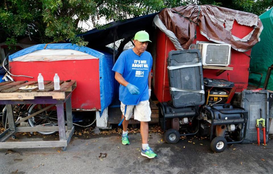 Pastor Frank Diaz of United We All Can Community Services delivers food to convicted child sex offenders at an encampment at 3600 Northwest 48th Street.